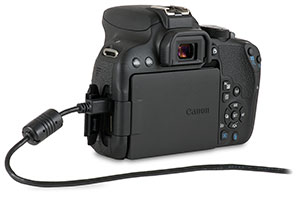 Canon T7i camera with USB cable in side port and open door